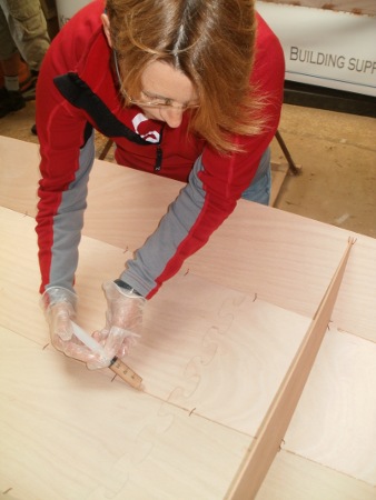 Filleting joints in a wooden kayak with an epoxy syringe